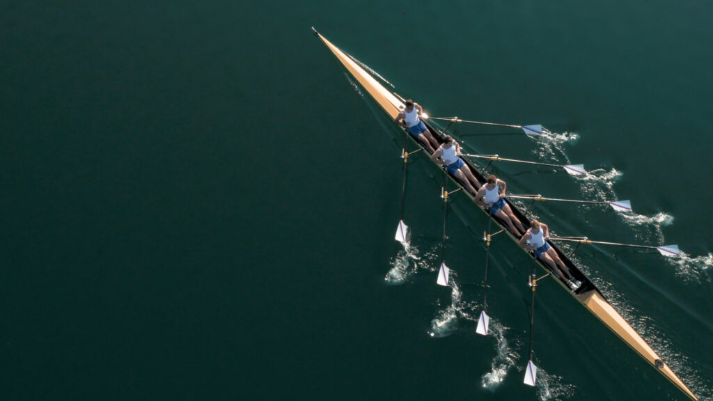 A team of professional rowers gliding through a river