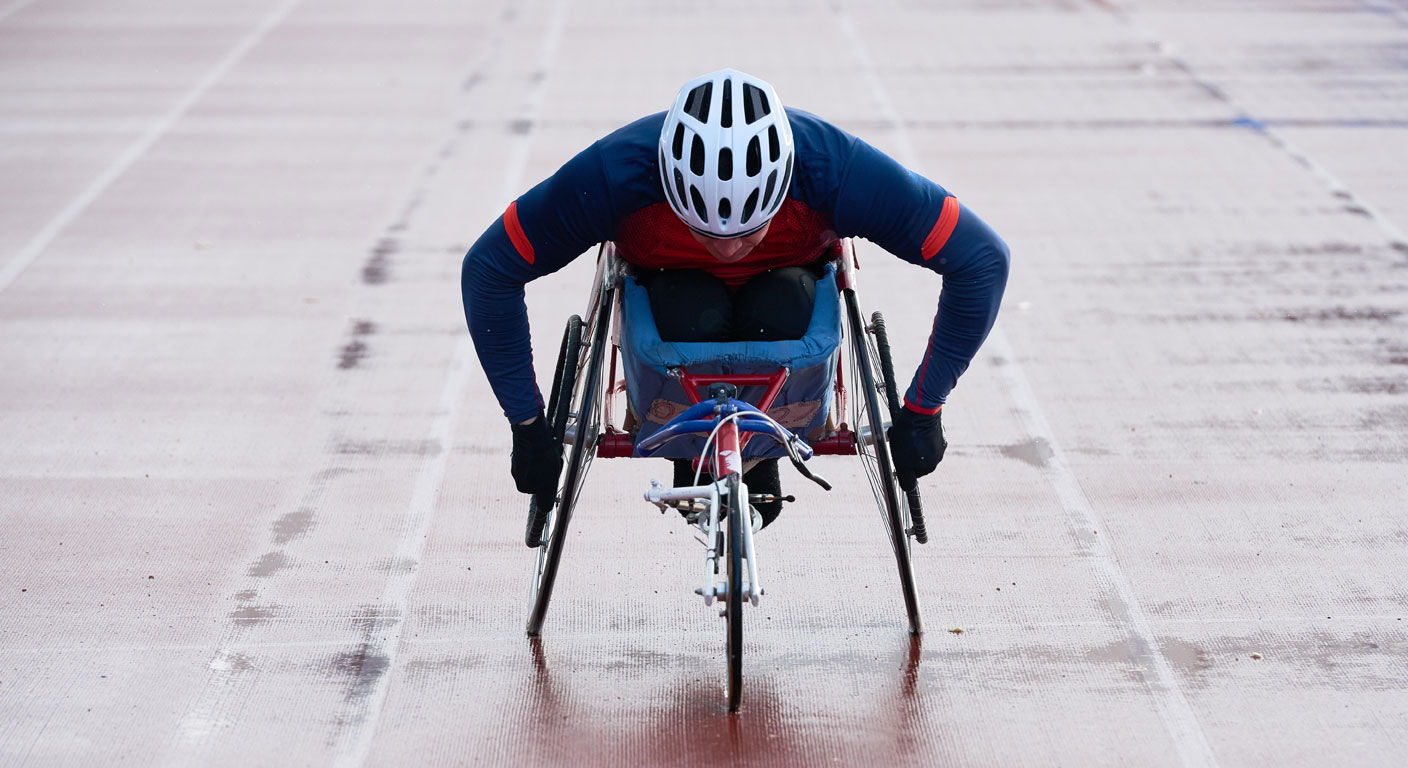 A para-athlete sprinter in a sports wheelchair on a track