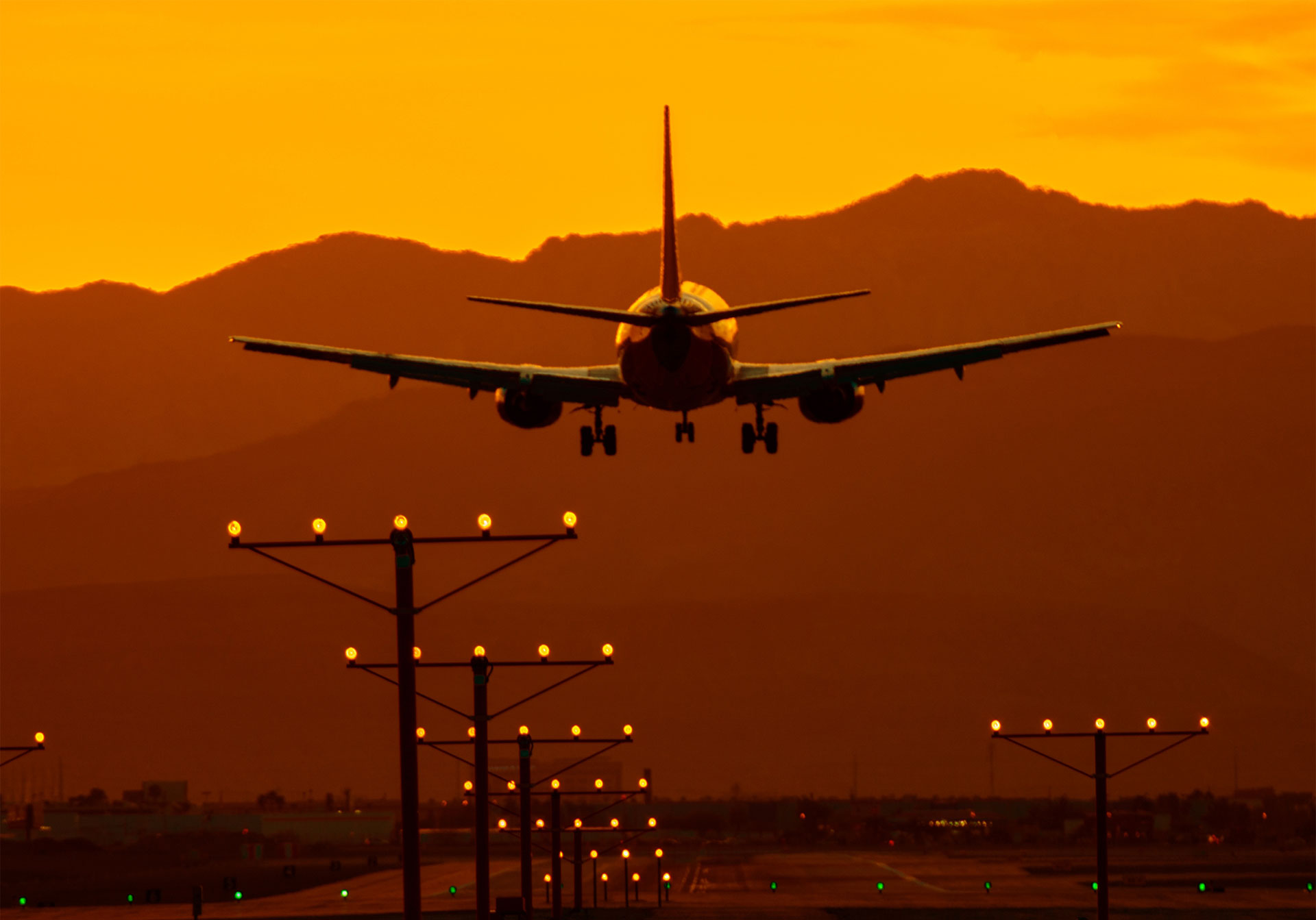 airplane taking off in sunset