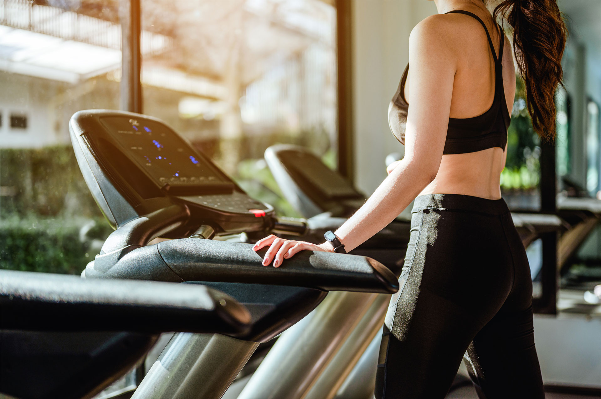 A coach helping an athlete on a treadmill